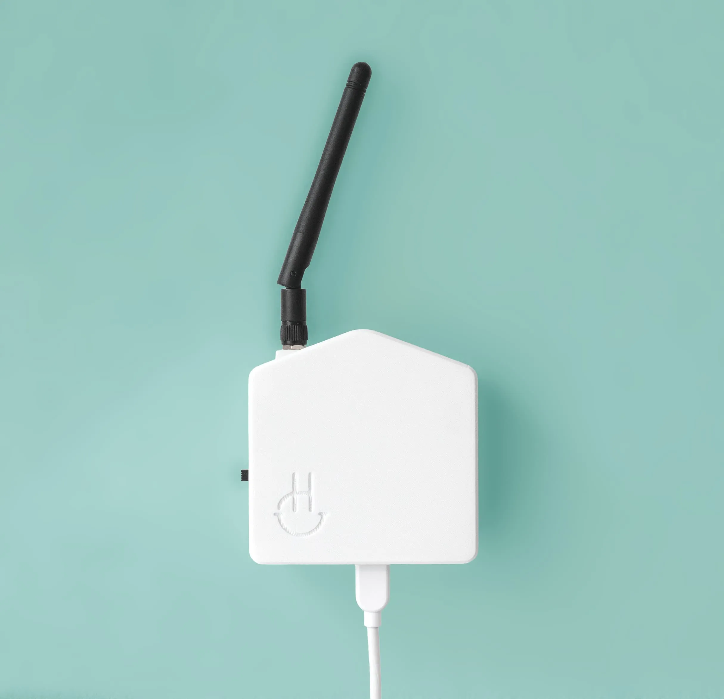 Product photograph of the sensor, antenna raised, on a teal backdrop.