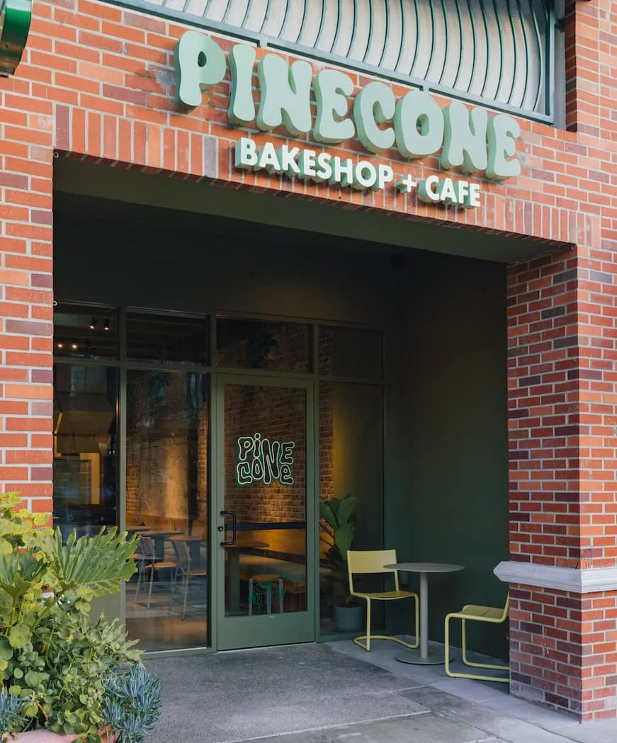The Pinecone storefront, with the dimensional wordmark sign above the entrance.